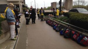 Homeless youth set up 25 backpacks outside a luxury condo building where Gov. Bruce Rauner has one of his nine homes, to compare the only storage the homeless have to what the governor has. (Credit: Mike Krauser)