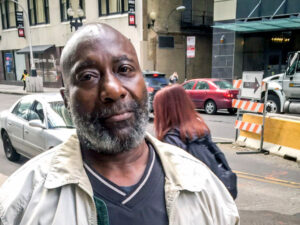 African American man standing along urban street