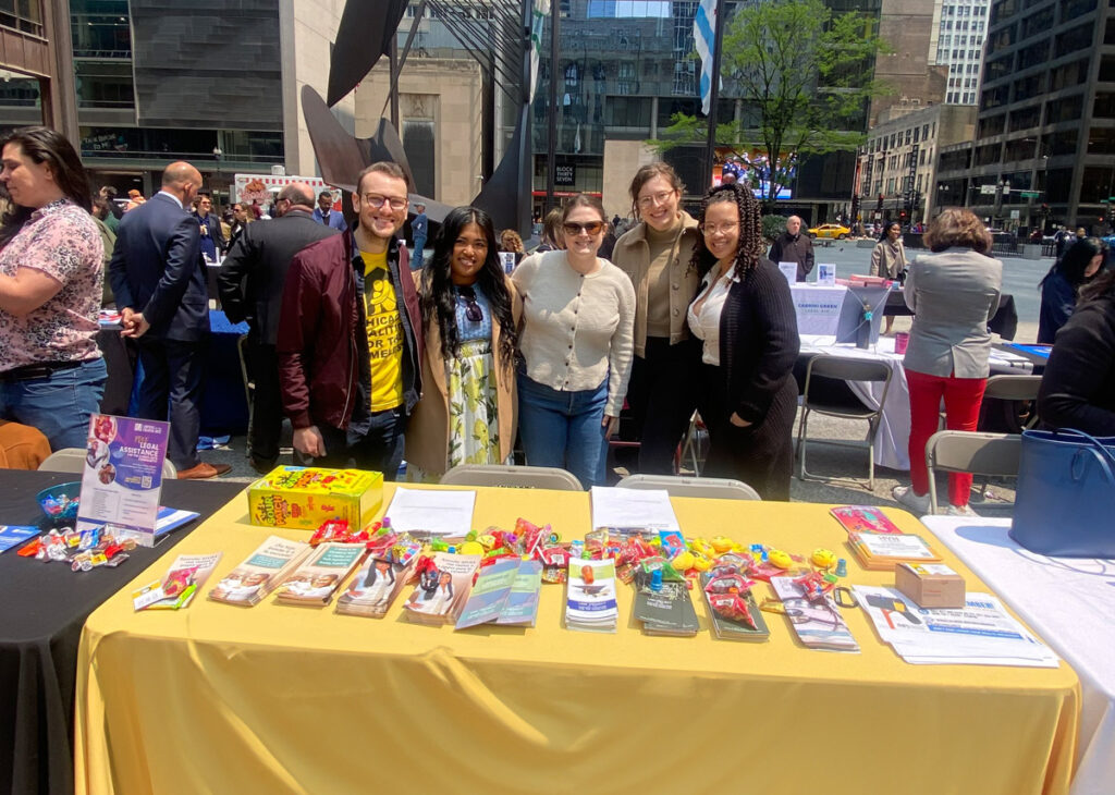 group of people at Law Project table in a plaza