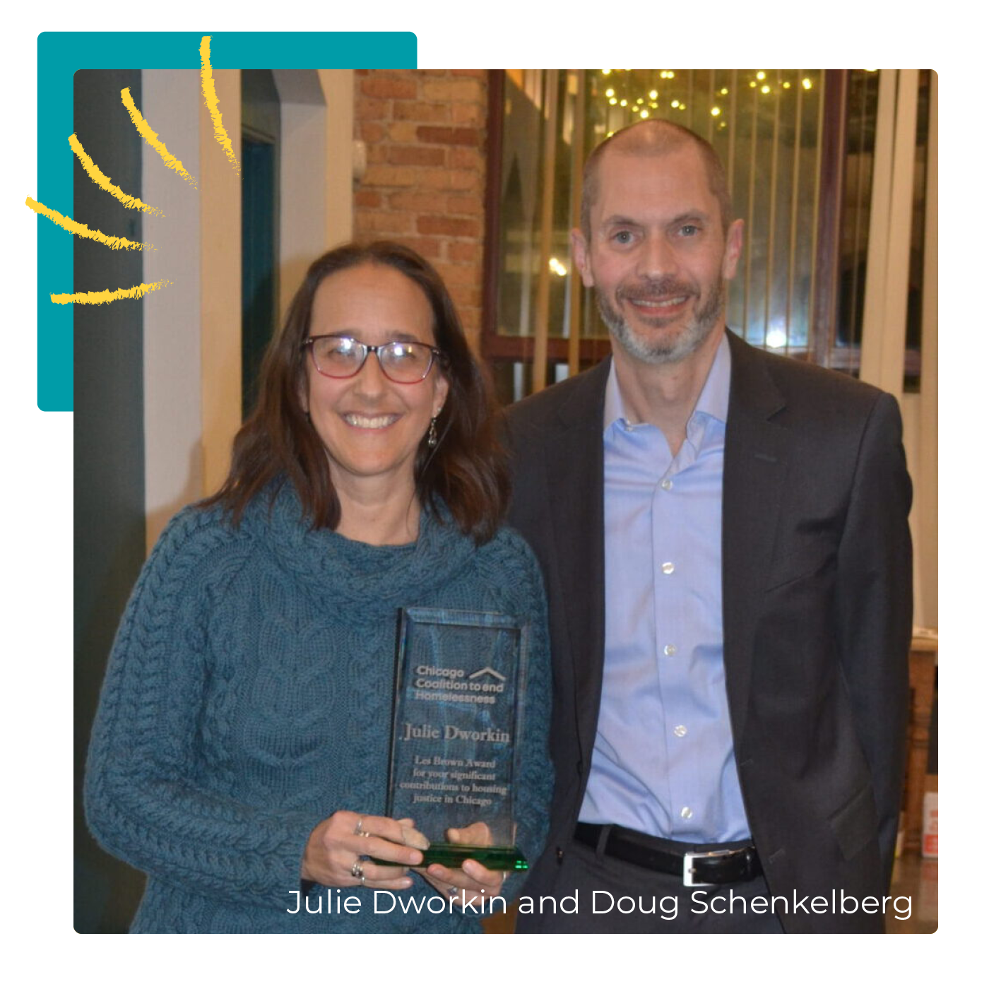 Julie Dworkin holds her award from CCH's annual Victory celebration while smiling and standing with Doug Schenkelberg.