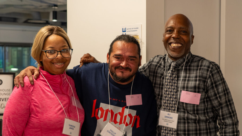 3 people smile at the camera.