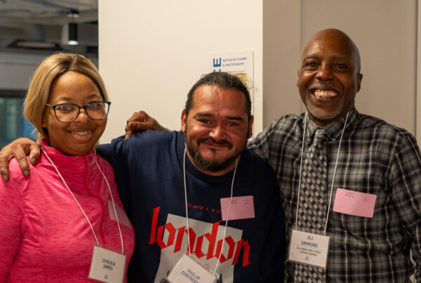 3 people smile at the camera.